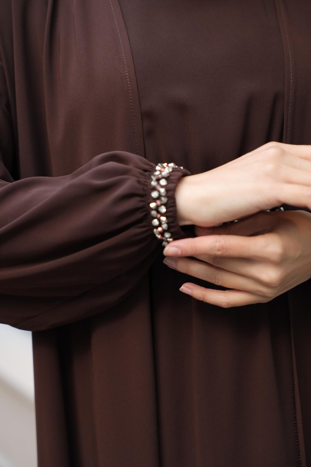 İthal Medine İpeği Boncuk İşlemeli Abaya TakımıŞıklığı ve zarafeti bir arada sunan ithal Medine İpeği boncuk işlemeli ikili abaya takımı ile tanışın! Özel olarak tasarlanan bu takım, kristal dikme boncuklarıyla göz kamaştıran detaylara sahiptir. Boyu 145
